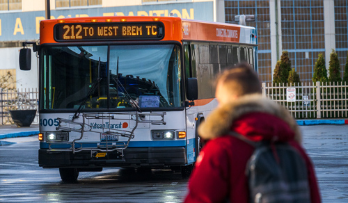 Kitsap Transit Route 212 in background with Blurry man in front. 